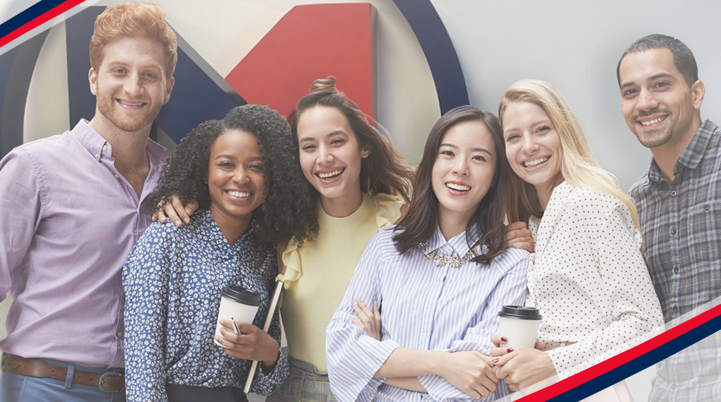 People standing in front of business logo