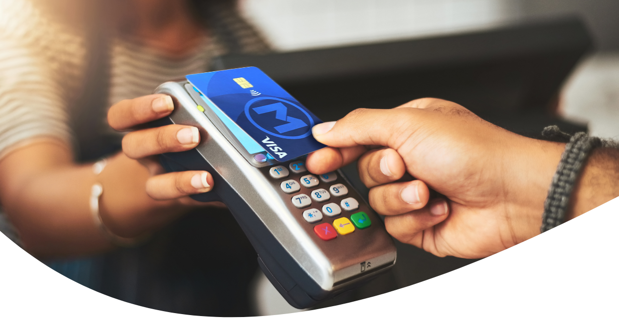 Person making contactless payment with credit card