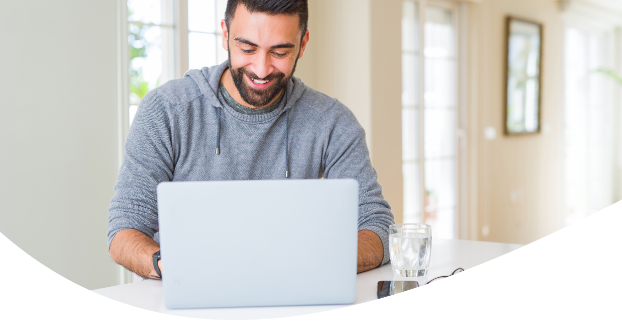 Smiling man working on laptop