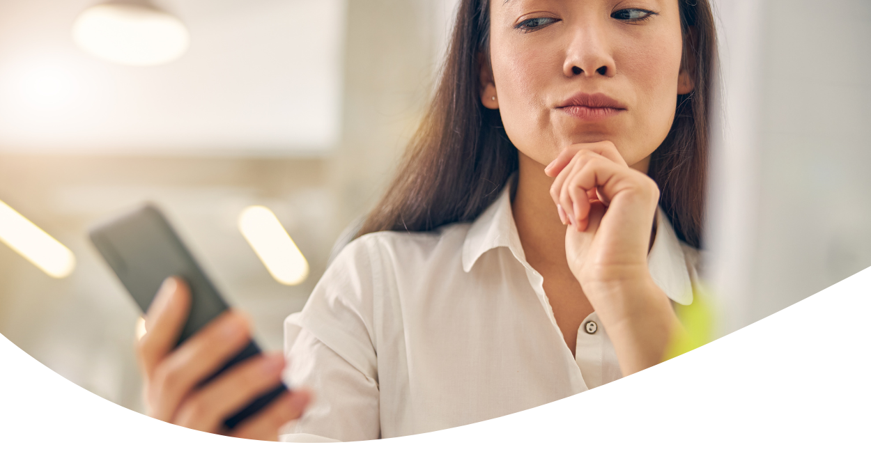 Contemplative woman looking at cellphone