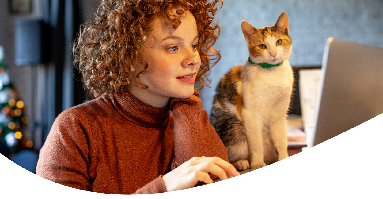 woman with cat shopping on laptop