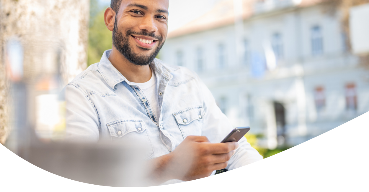 Smiling man holding smart phone