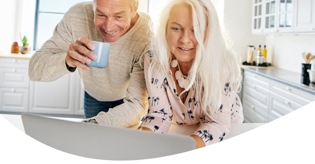 middle-aged couple looking at laptop