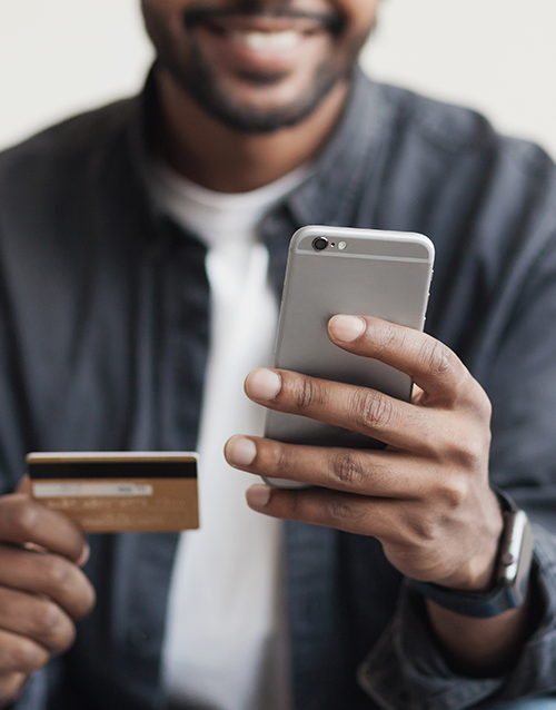 man holding credit card and cellphone