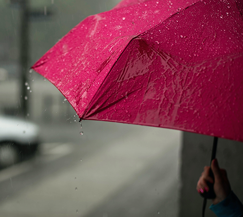 holding umbrella in rain