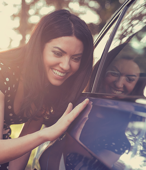 Woman looking at new car