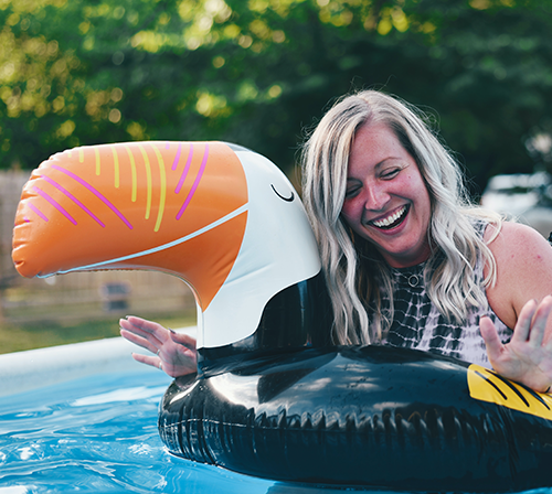 woman in pool with floatie