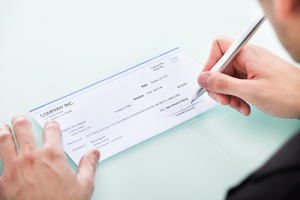 photo of person writing check