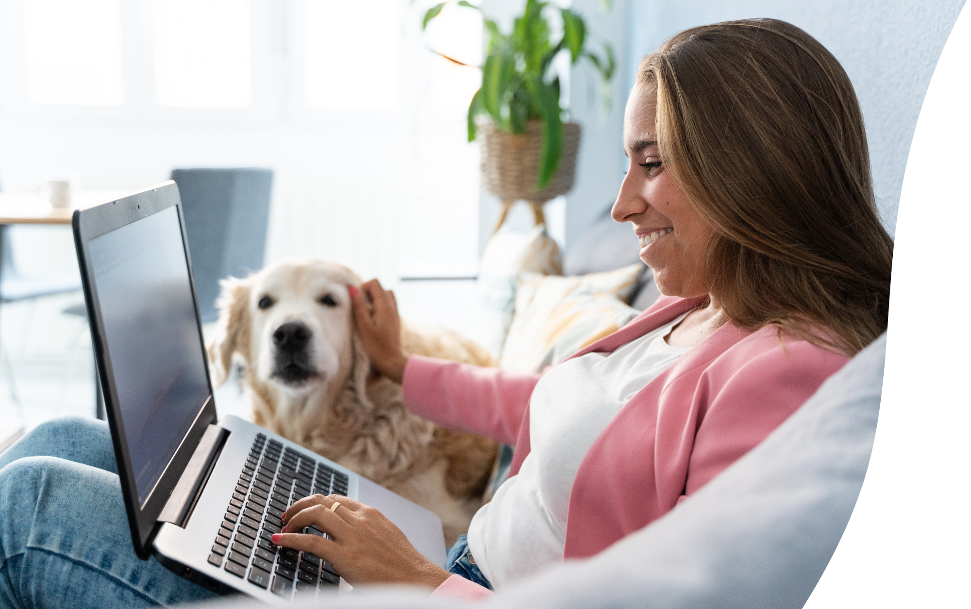 Woman with laptop petting dog