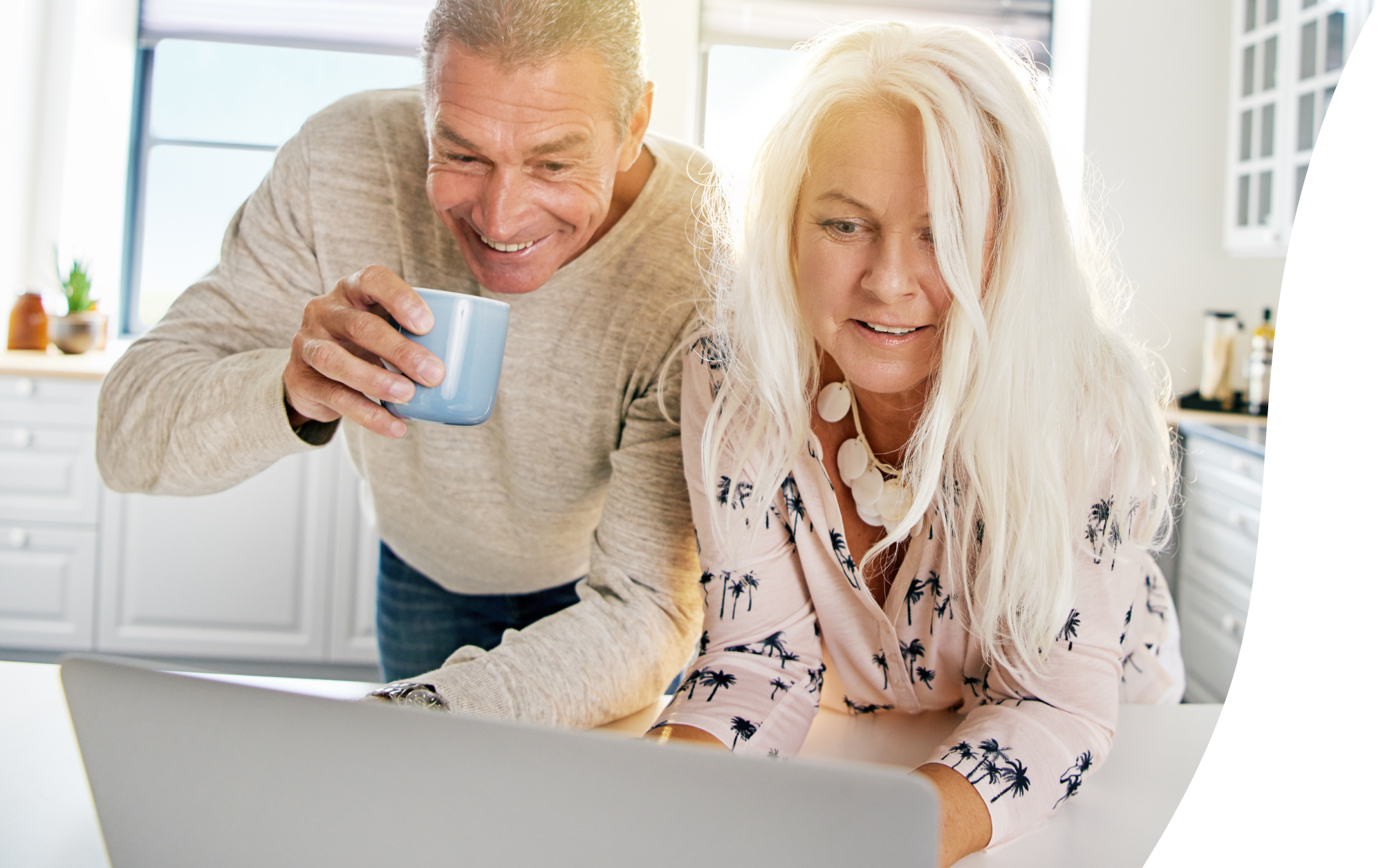 middle-aged couple looking at laptop