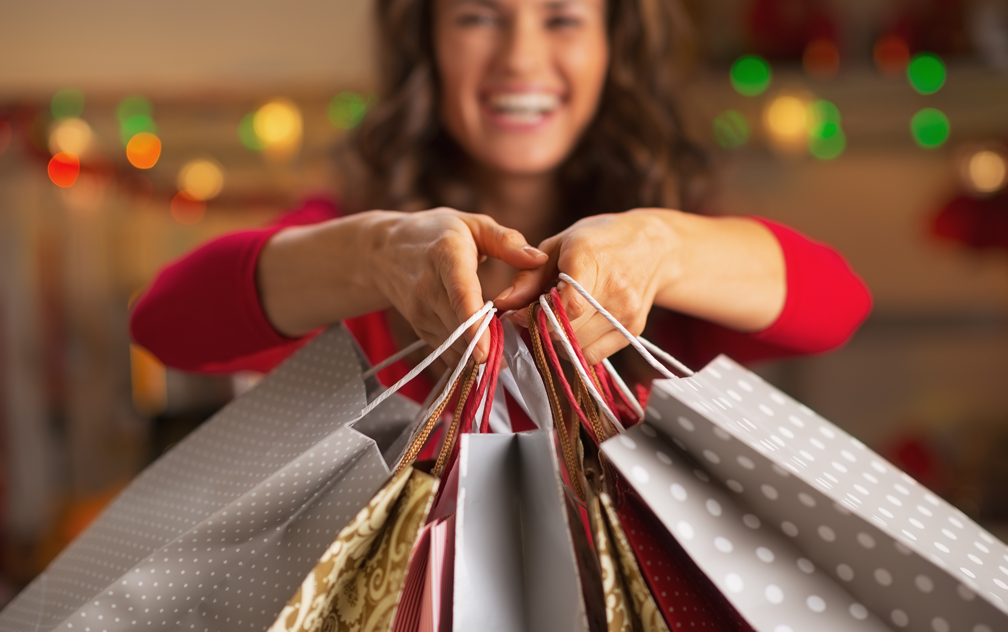 woman holding festive gift bags