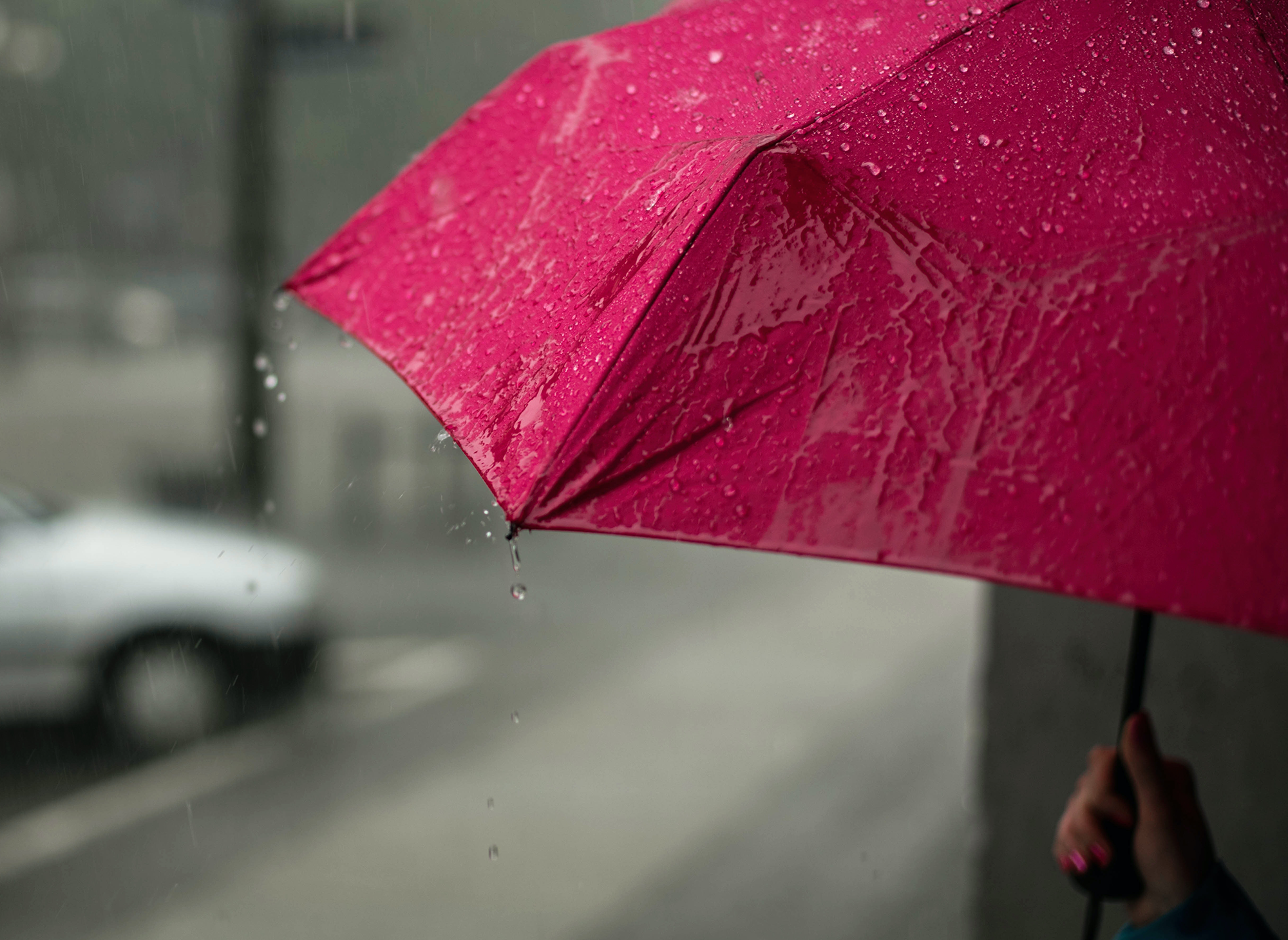 holding umbrella in rain